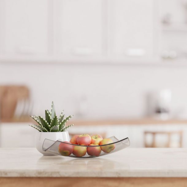 White kitchen with marble countertop and bowl of apples