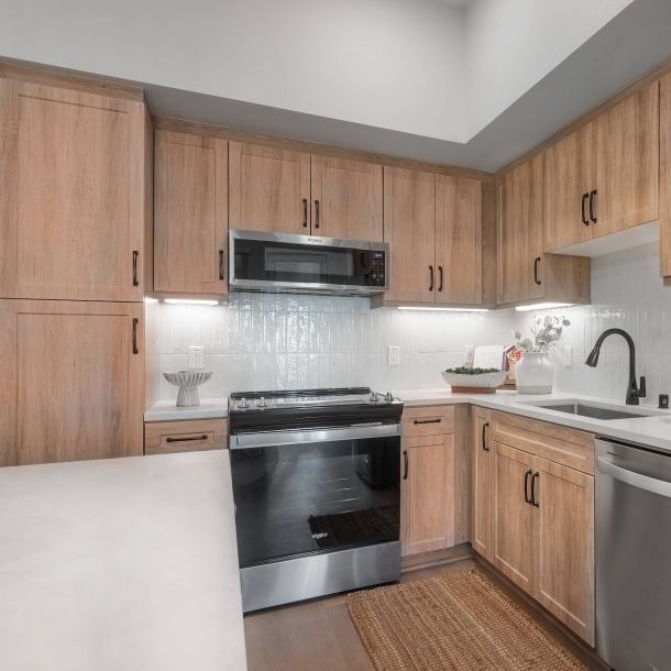 Solana Winchester Hills apartment kitchen interior with stainless steel appliances and wooden cabinets