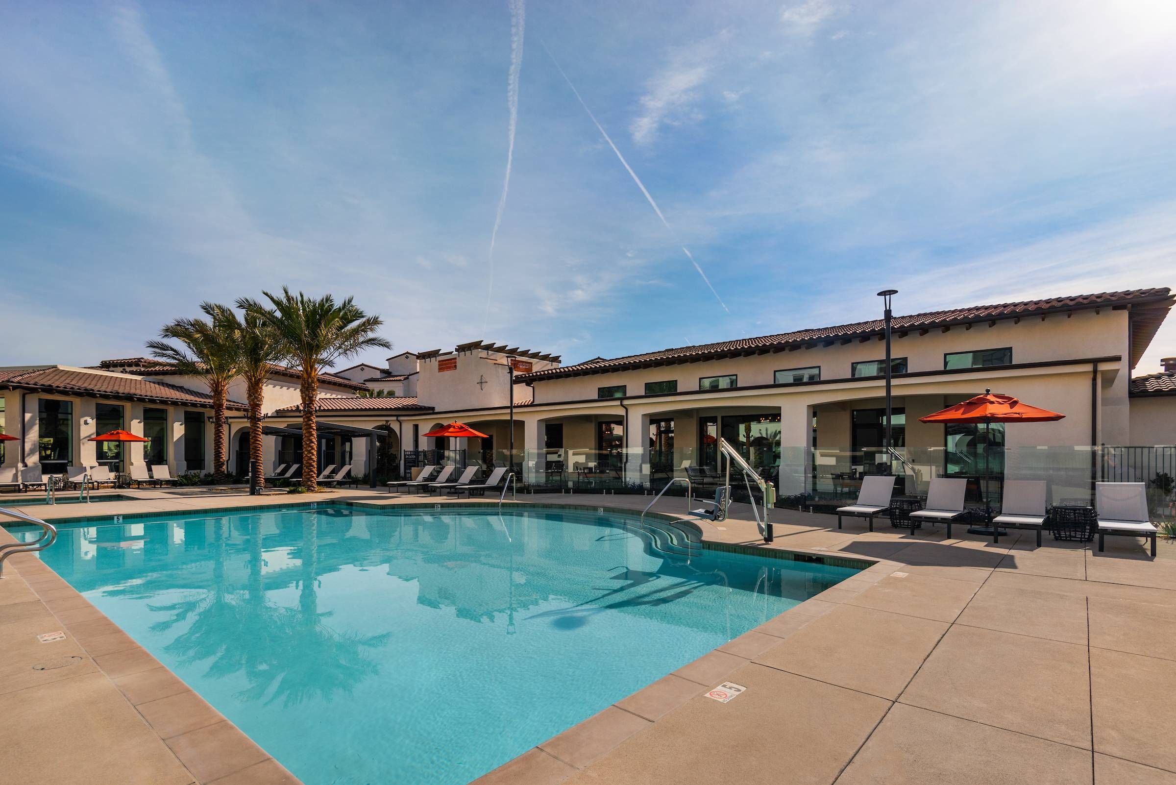 Resort‑style pool with umbrella and loungers at Solana Winchester Hills Temecula apartments.